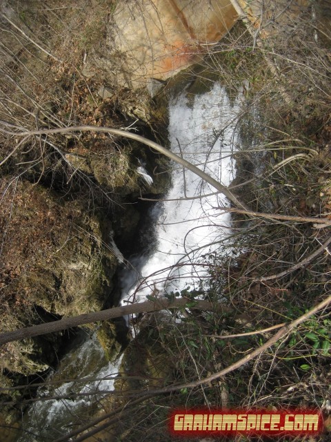 flowing stream waterfall outlet under road