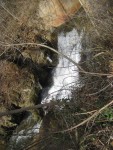 flowing stream waterfall outlet under road