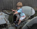 062207 Benjamin Grey Mesko in the backyard on the tractor - Fairfield VA