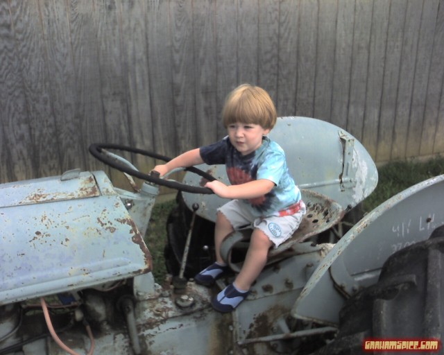 062207 Benjamin Grey Mesko in the backyard on the tractor - Fairfield VA
